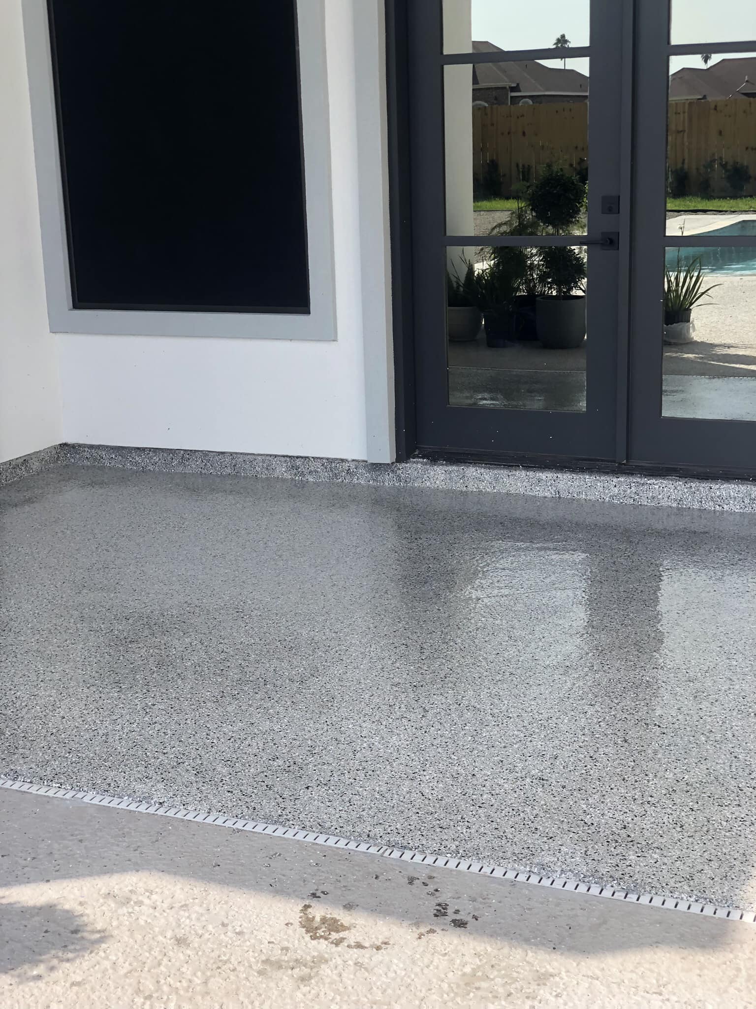 White sports car on a lift above a copper metallic epoxy floor.